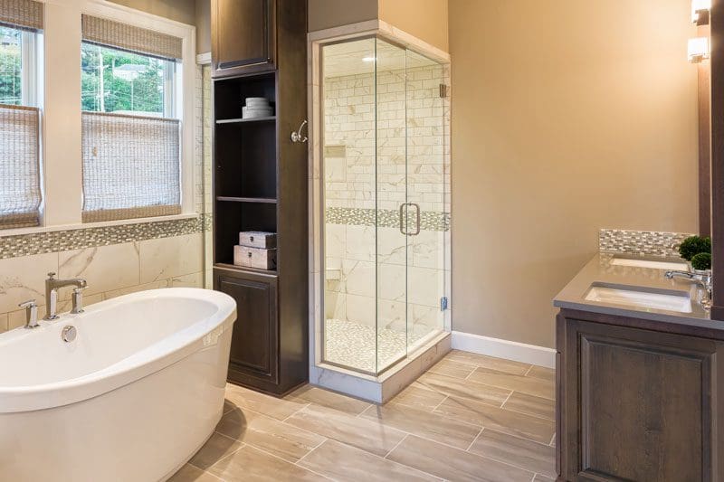 Remodeled bathroom with a separate bath tub and glass walk in shower