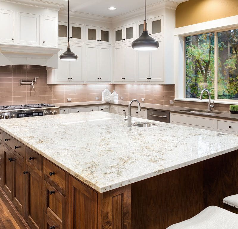 Kitchen with white granite countertops and large island